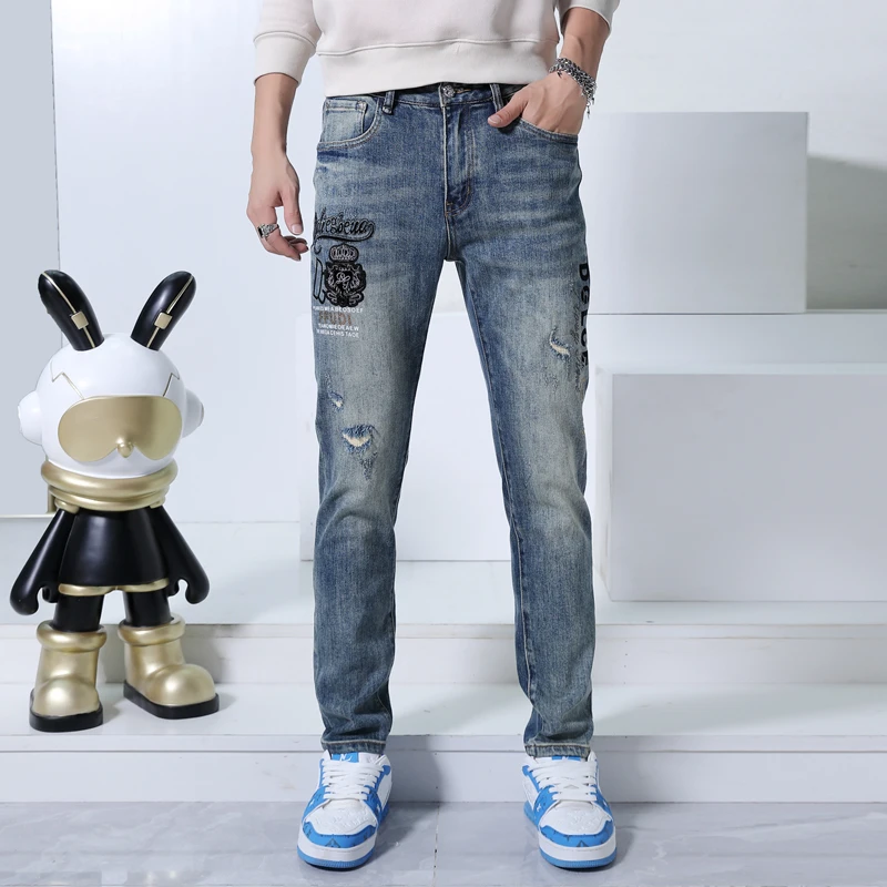 高端男士春秋牛仔裤刺绣烫钻破洞时尚个性修身小脚重工水洗长裤