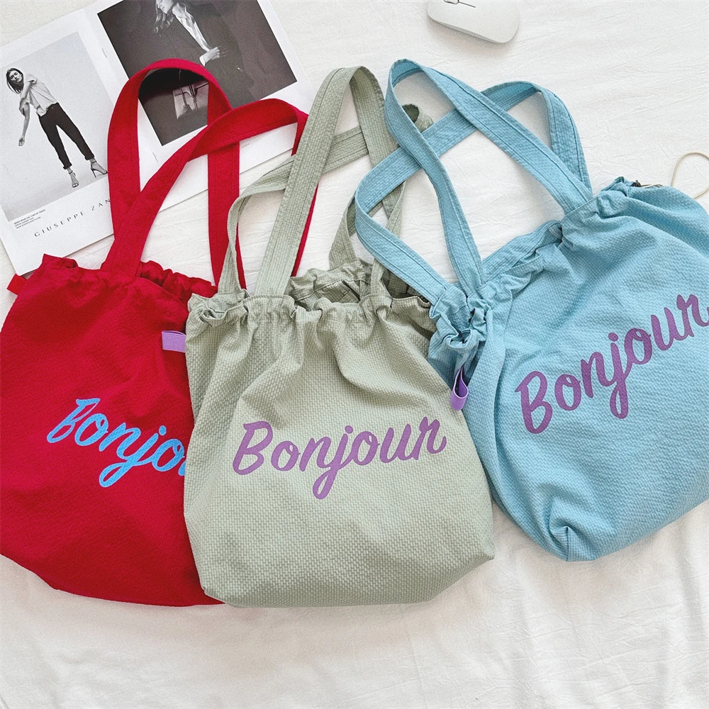 百搭外出旅游轻便尼龙大容量便携包包女新款字母印花抽绳帆布包