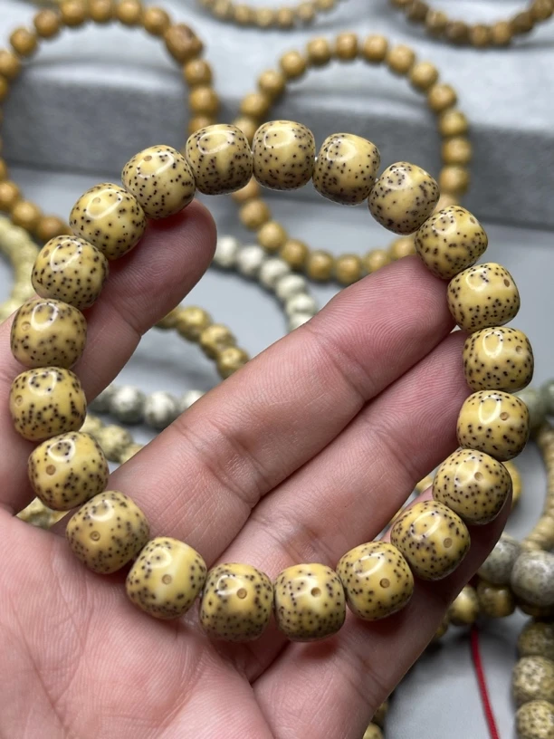 海南星月菩提原生态石玉料大眼睛通同枝果手串