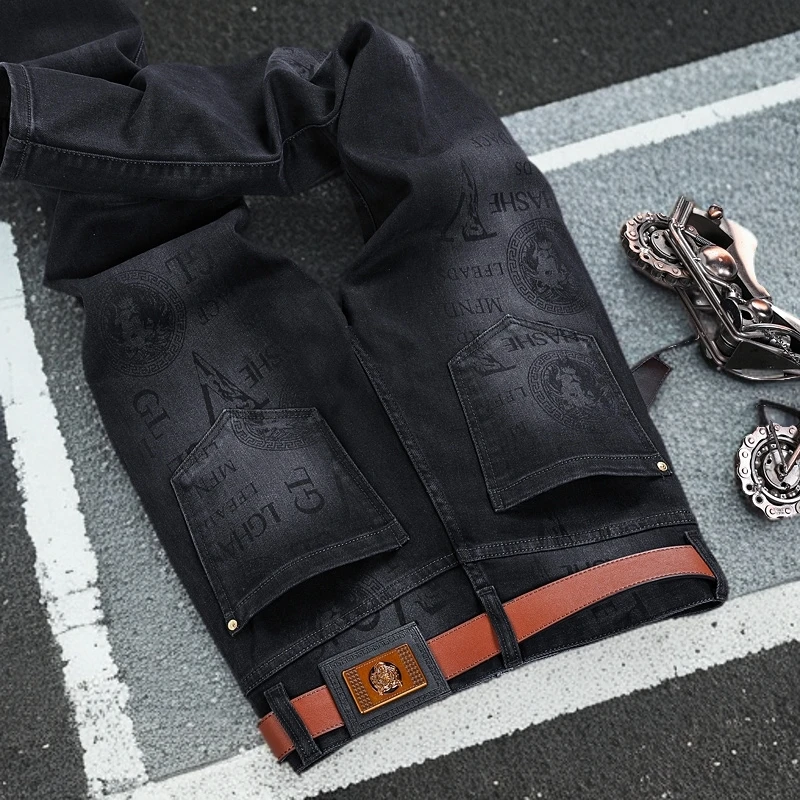 高端潮牌韩版牛仔裤男士修身小脚长裤弹力休闲百搭黑色九分裤印花