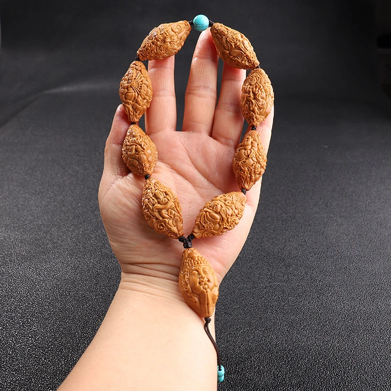 天上人间橄榄核雕手持