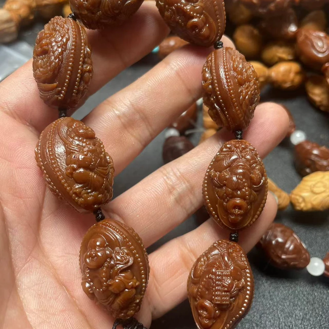 橄榄核玉化料九龙弥勒手串