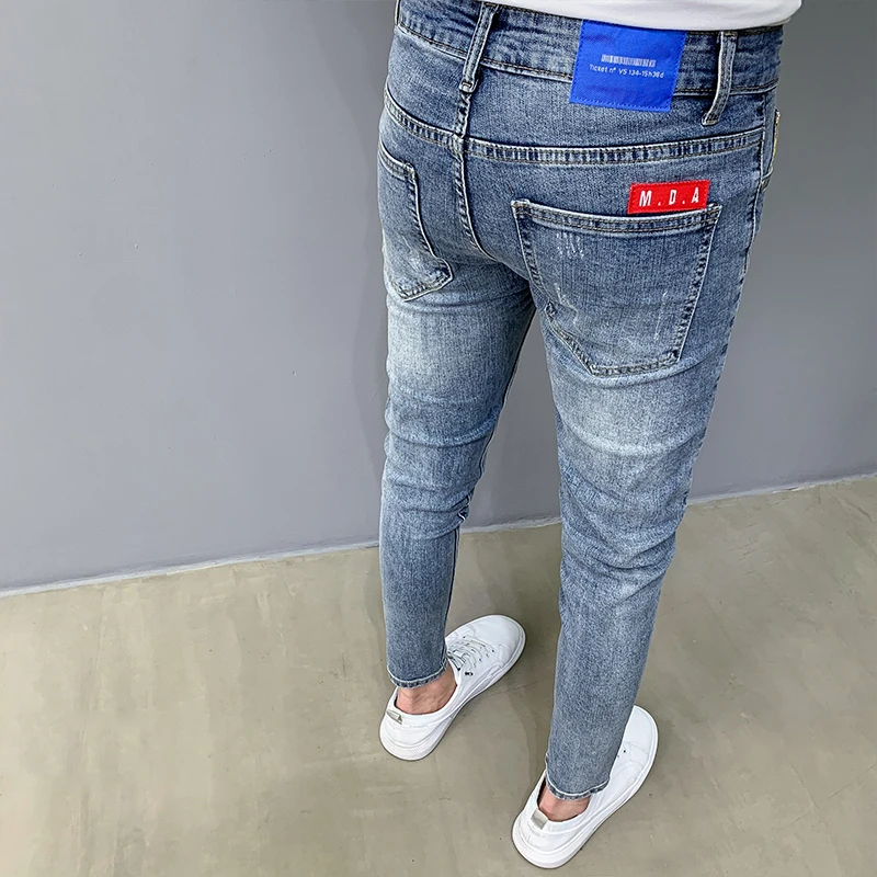 蓝色九分牛仔裤男韩版潮流破洞贴布百搭时尚2025新款修身小脚长裤
