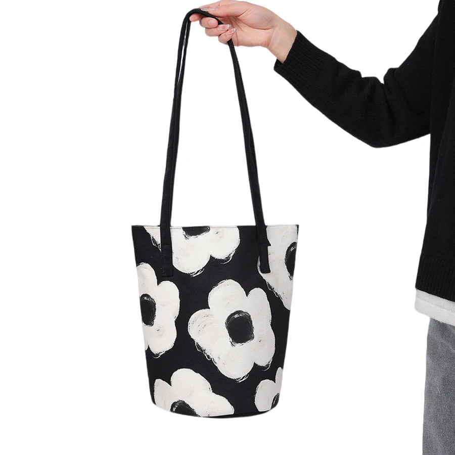 尼睿新款黑白简约复古花卉单肩包休闲百搭文艺水桶包帆布包通勤