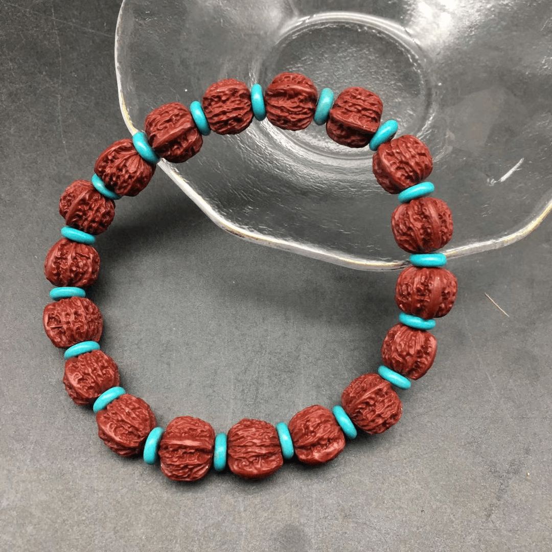 ZA158-朱砂紫金砂雕刻核桃珠带蓝色隔片单圈手串