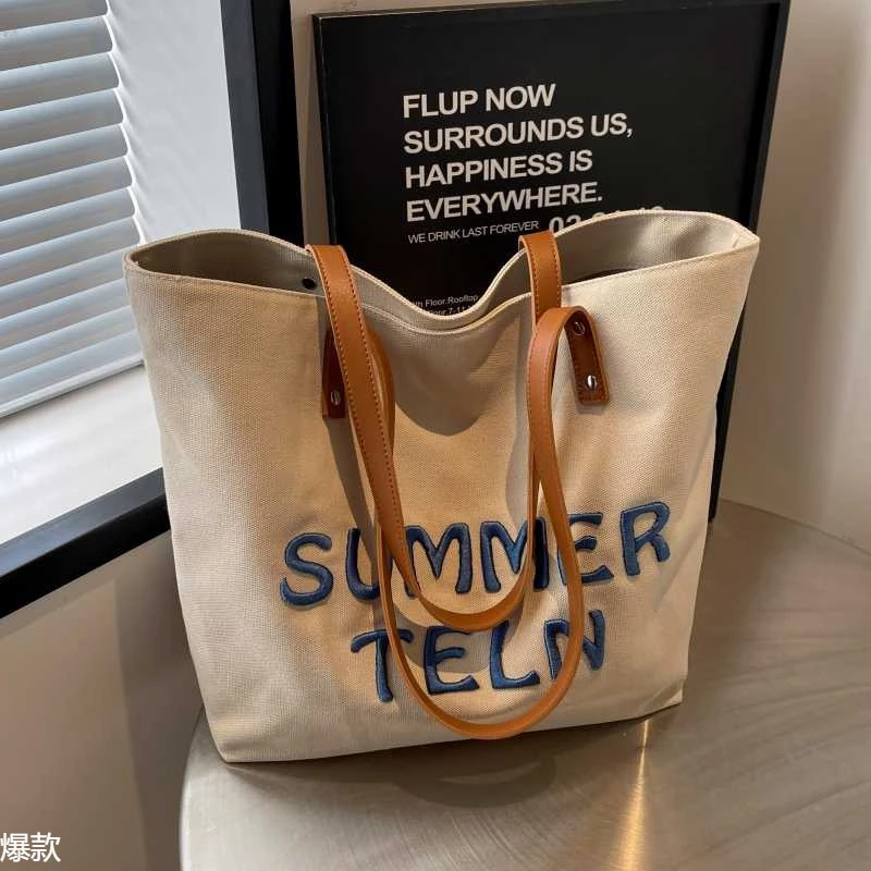 刺绣字母帆布包女2025新款大容量通勤托特包百搭单肩大学生上课包