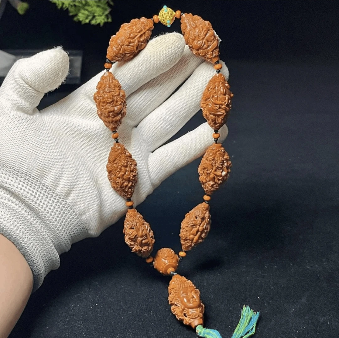 橄榄核雕镂空九龙万佛玉化料