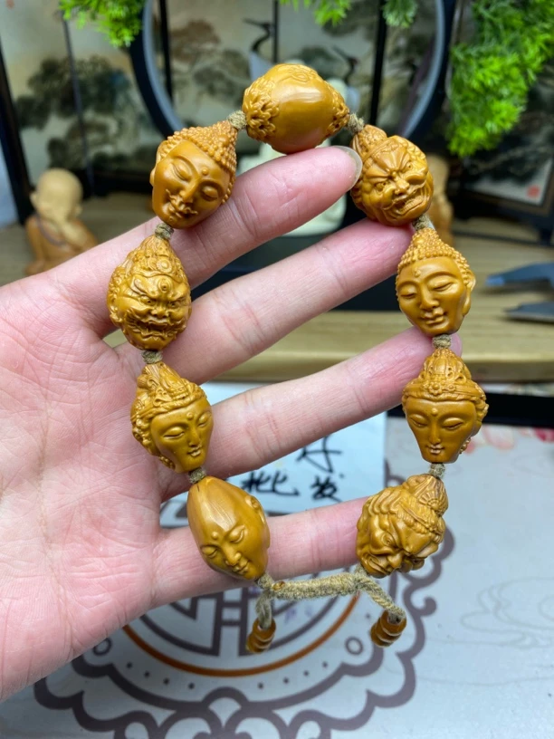 橄榄核雕工艺手串强万佛朝宗