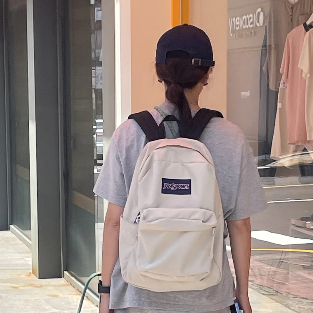 Jansport25年新款奶漾女学生书包轻便户外双肩背包通勤电脑背包