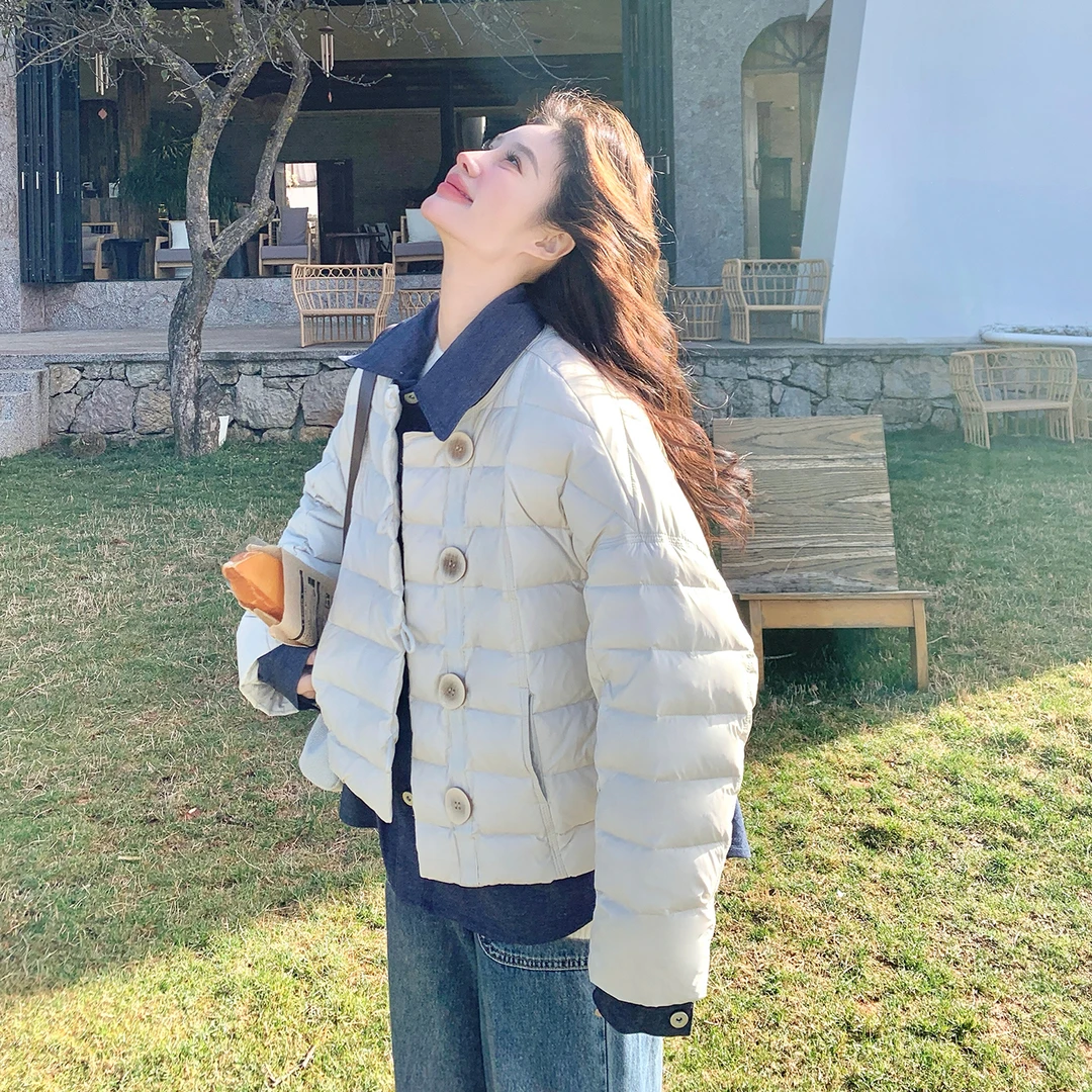 设计感牛仔拼接假两件羽绒服女冬2025新款韩版时尚休闲白鸭绒外套