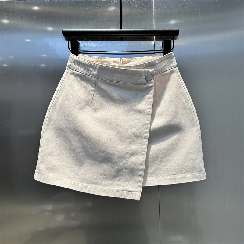 错位斜扣米白色高腰水洗A字牛仔短裙2025夏季新款时尚洋气半身裙