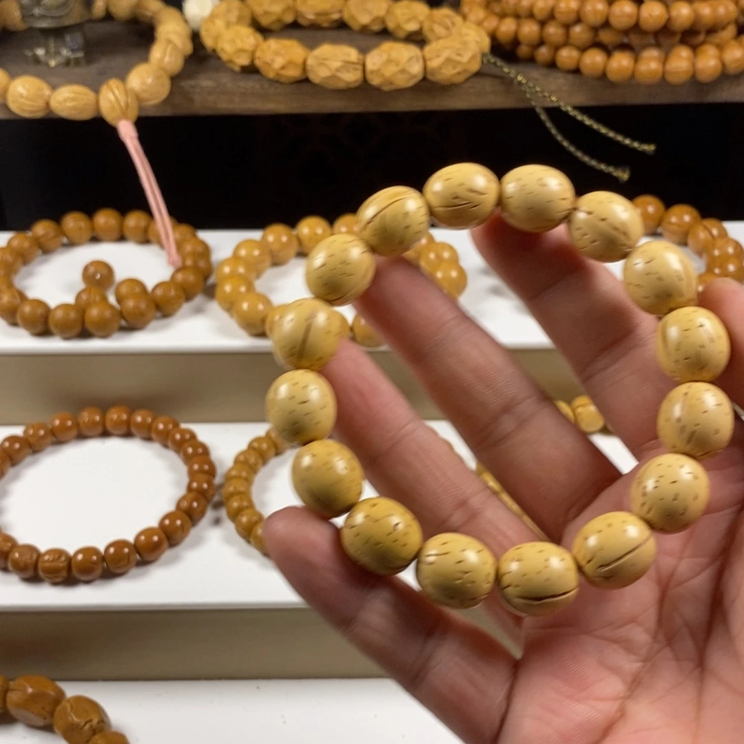 张***.吊坠桃核盘锦奶油核枣珠单圈