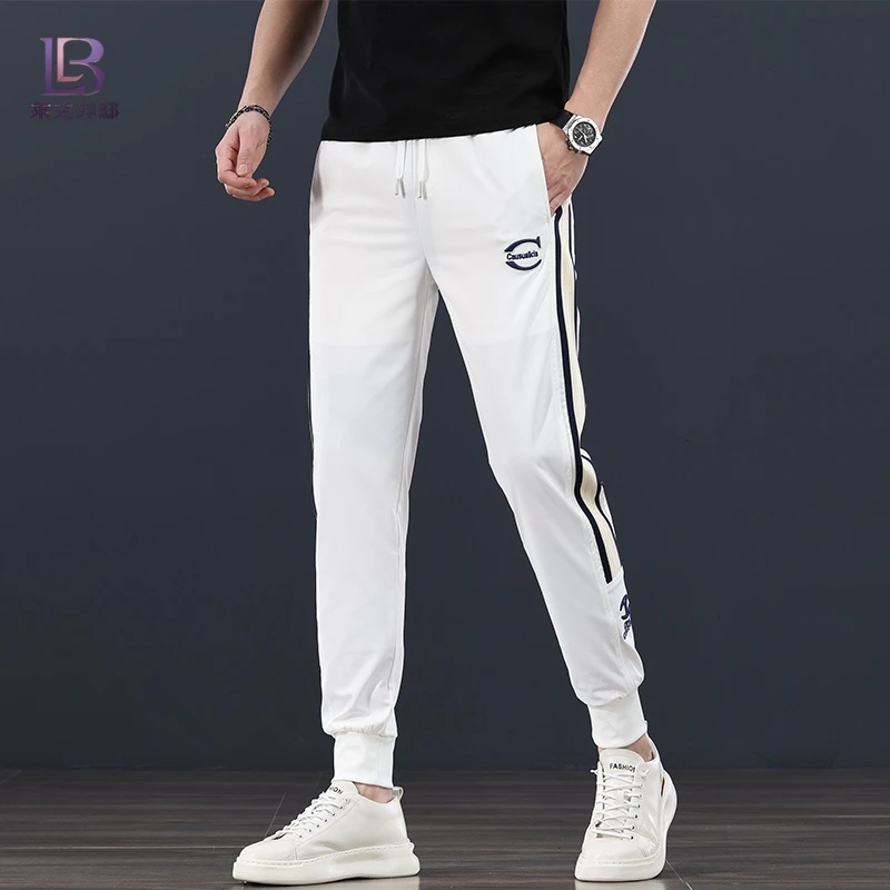 潮流白色哈伦裤男2025夏季新款速干冰丝束脚运动裤织带拼接休闲裤