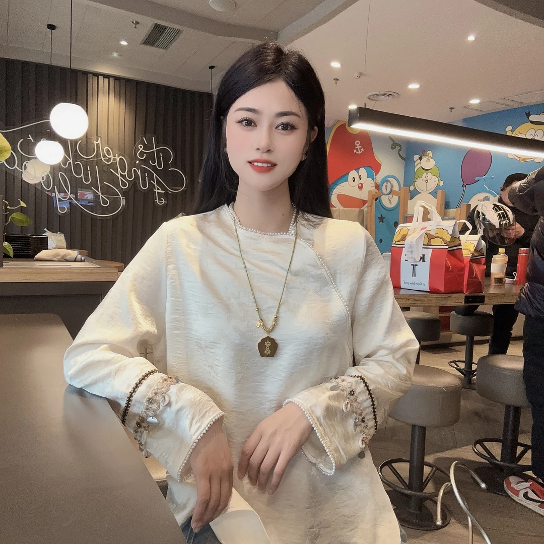 新中式民族风时尚显瘦珍珠圆领斜襟气质袖口重工流苏海螺衬衫