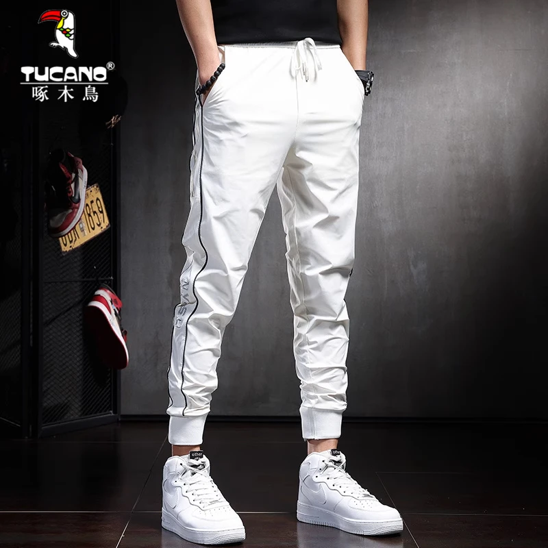 啄木鸟夏季薄款冰丝休闲裤男网红同款速干裤男白色修身运动裤束脚