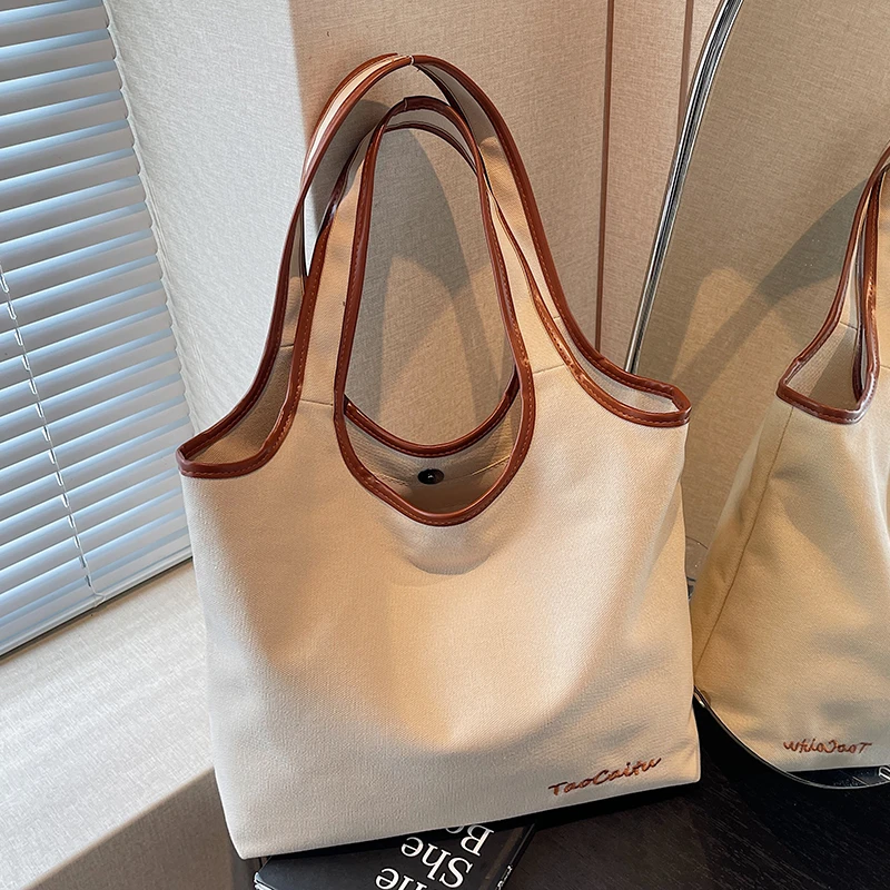 休闲百搭帆布包包女式2025新款轻便通勤单肩包大容量托特包水桶包