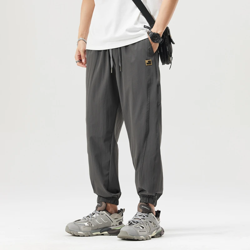 夏季宽松运动休闲裤男2025薄款速干透气弹力哈伦青年潮流裤子男款
