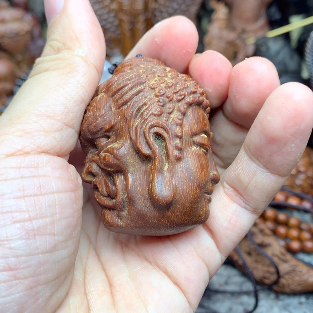 木木雕红土一念之间手把件