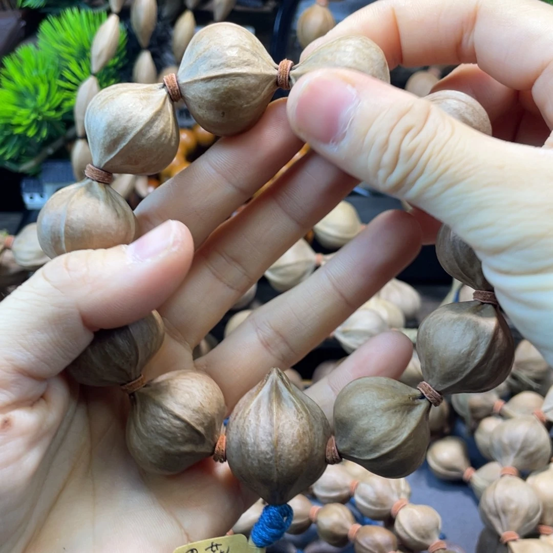 宁***为橄榄核吊坠2727雕刻料正四花