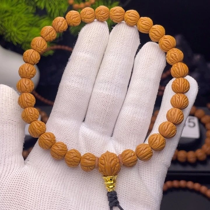 扎***德吊坠桃核小金豆0.95