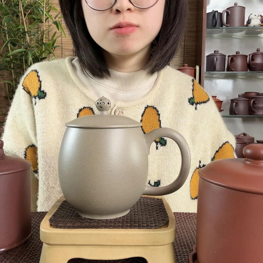 紫砂茶杯是****语青段镂空龙蛋办公杯480CC