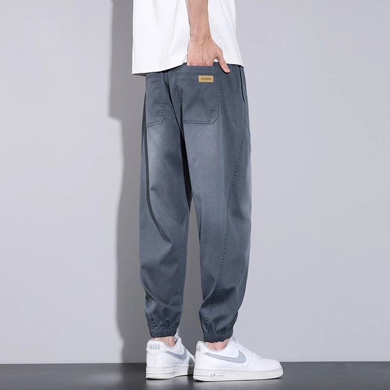 啄木鸟天丝牛仔裤男士夏季薄款哈伦束脚2025新款宽松运动休闲裤