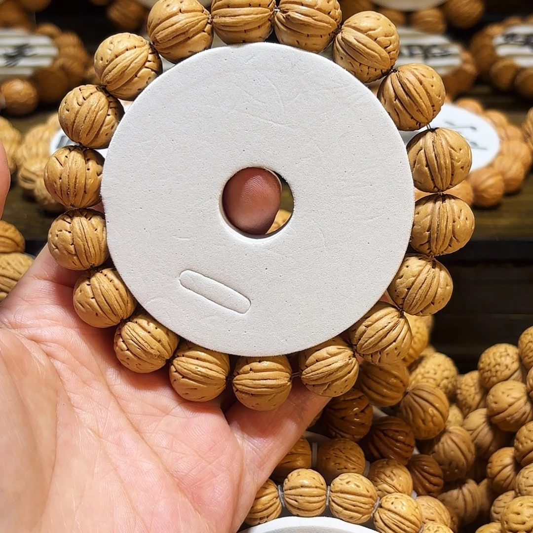 15尺寸桩矮1个半提溜圆桃核手串