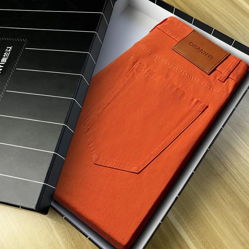 高级轻奢男款爆款2025新款弹力修身男士九分小脚彩色橙色牛仔裤