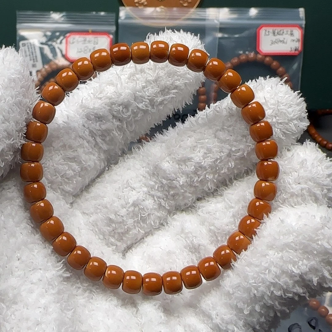 冲***冲橄榄核手串/手链6.3mm老挝红料三花核尖手串