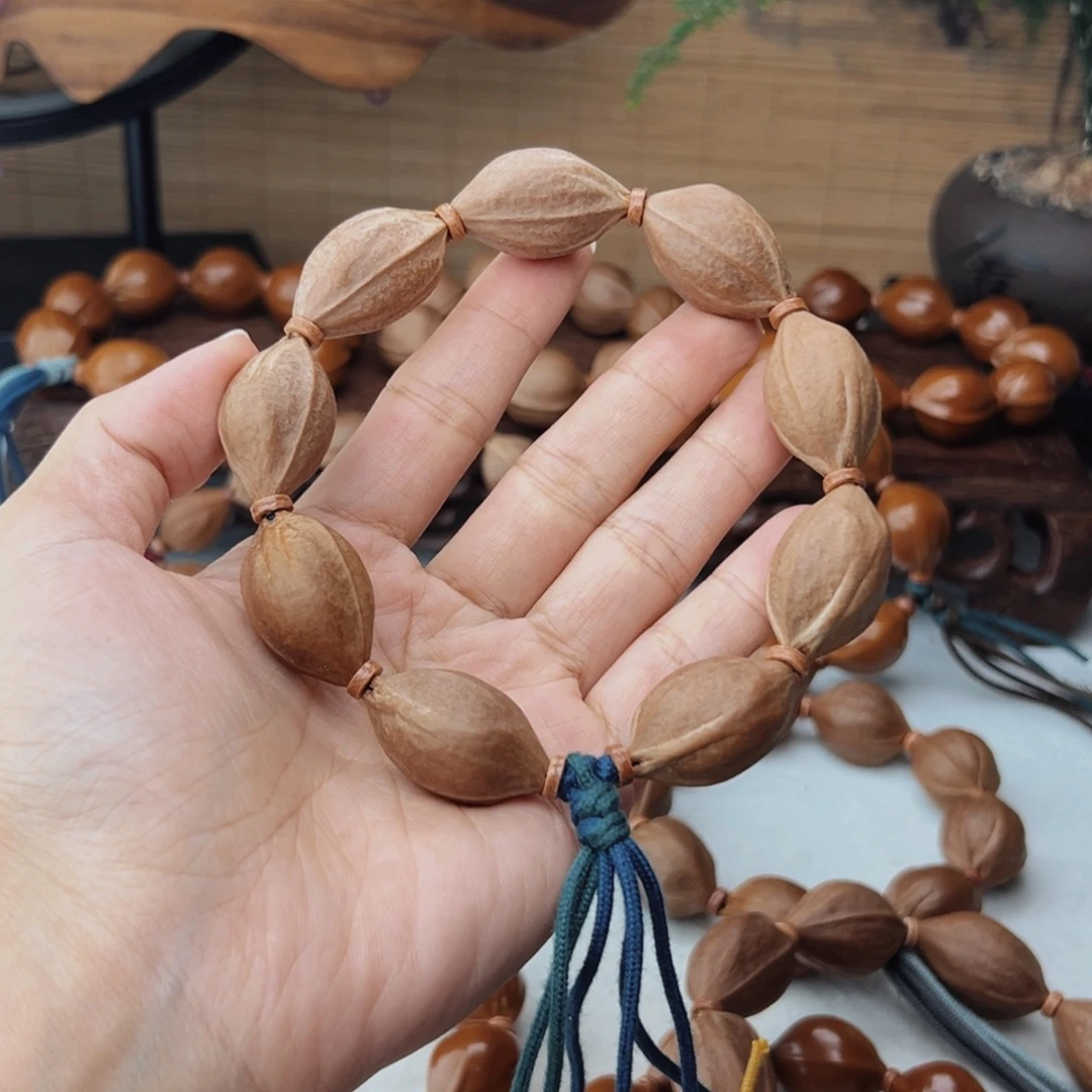 三***.手串橄榄核18*30三花核串