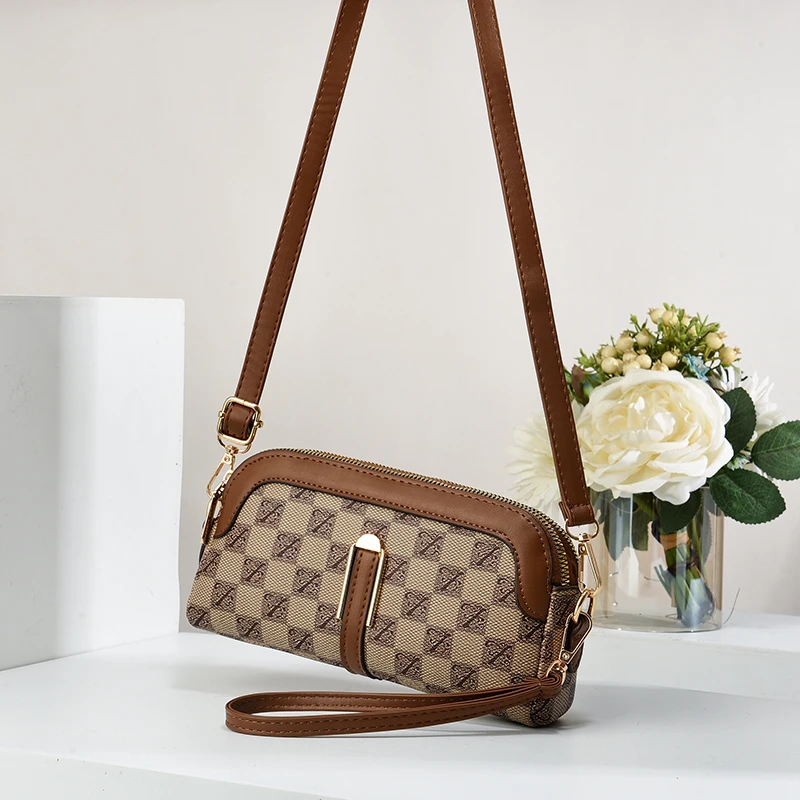 真皮质感包包女2025春季新款复古手拿包双隔层手机包潮流单肩包