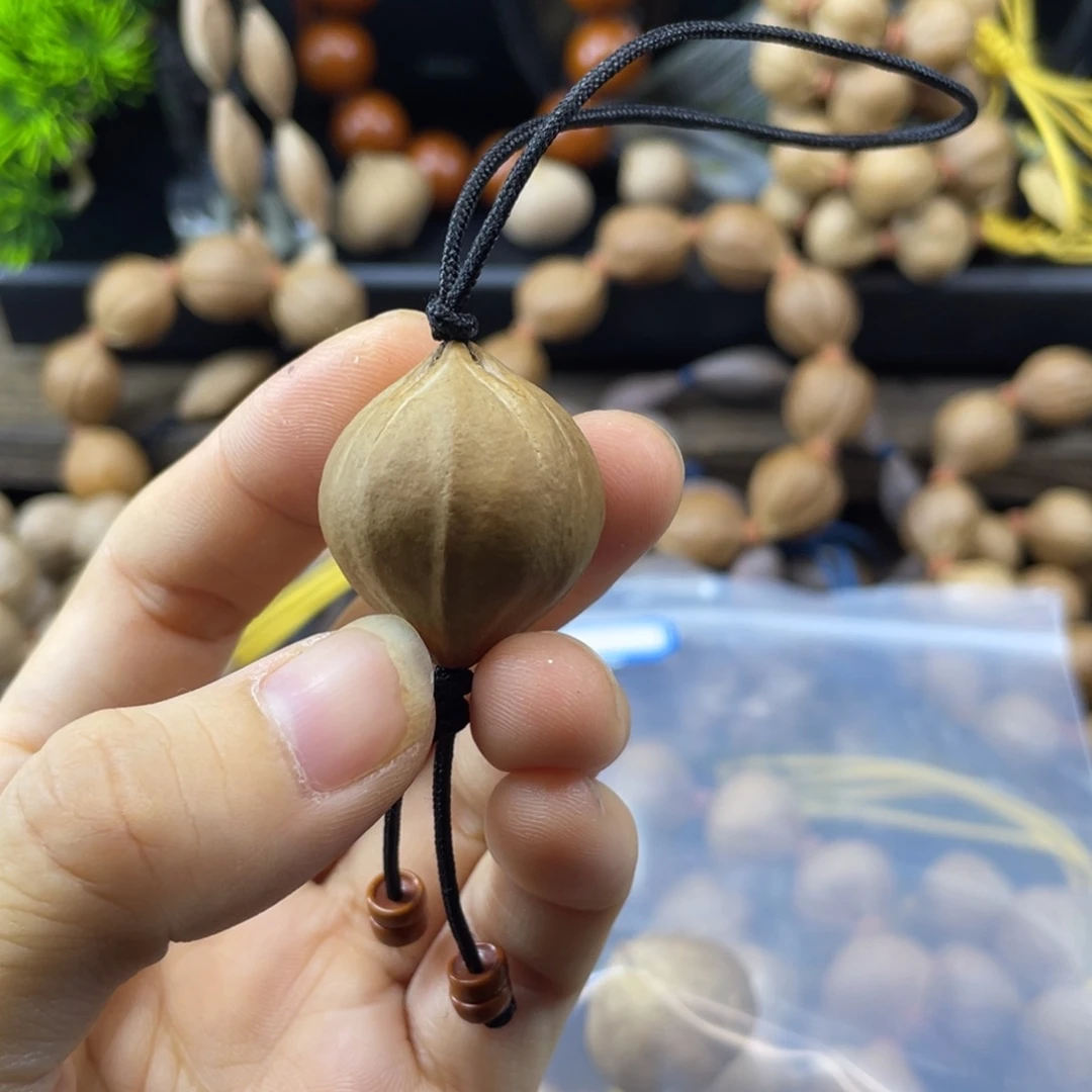 隐***来橄榄核吊坠009.单籽四花