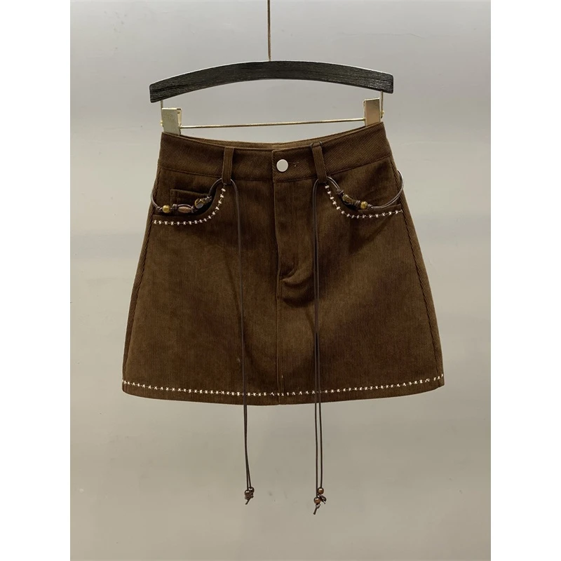 美拉德咖啡色灯芯绒半身裙女2025秋冬新款高腰防走光a字包臀短裙