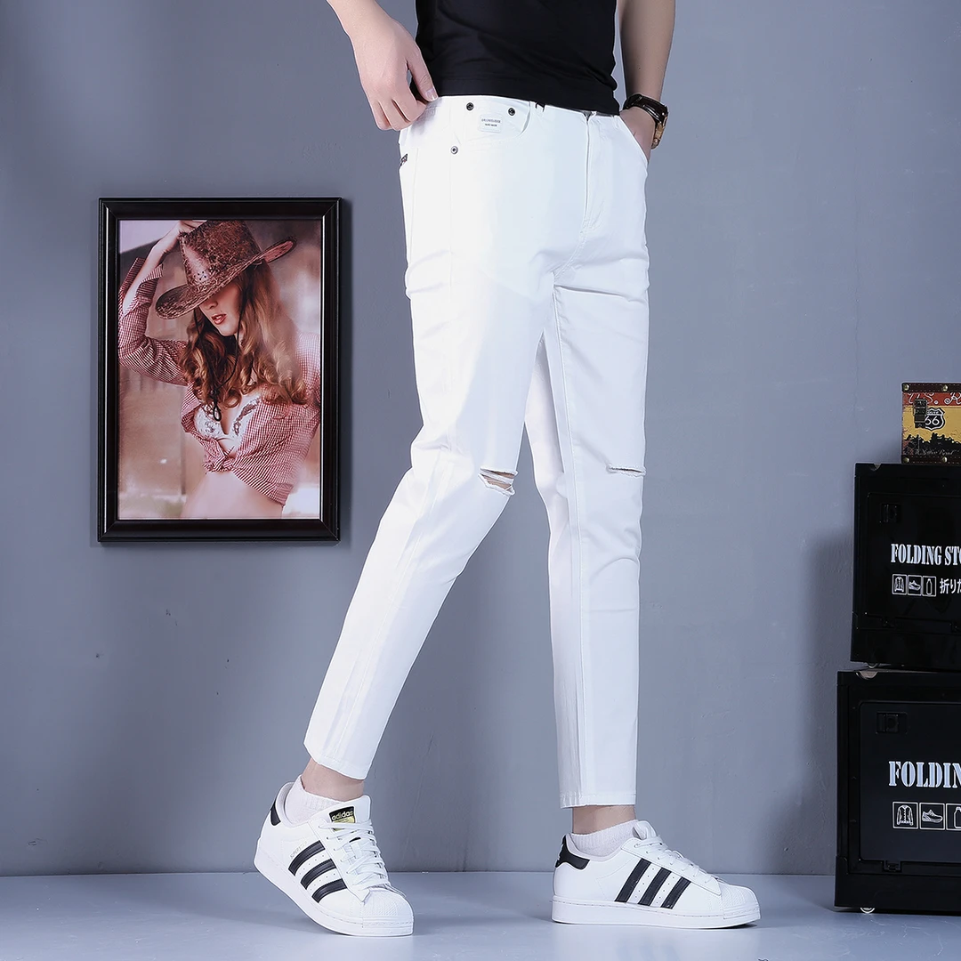 欧洲站高端白色破洞九分牛仔裤男士2025夏季新款小脚裤休闲裤子男