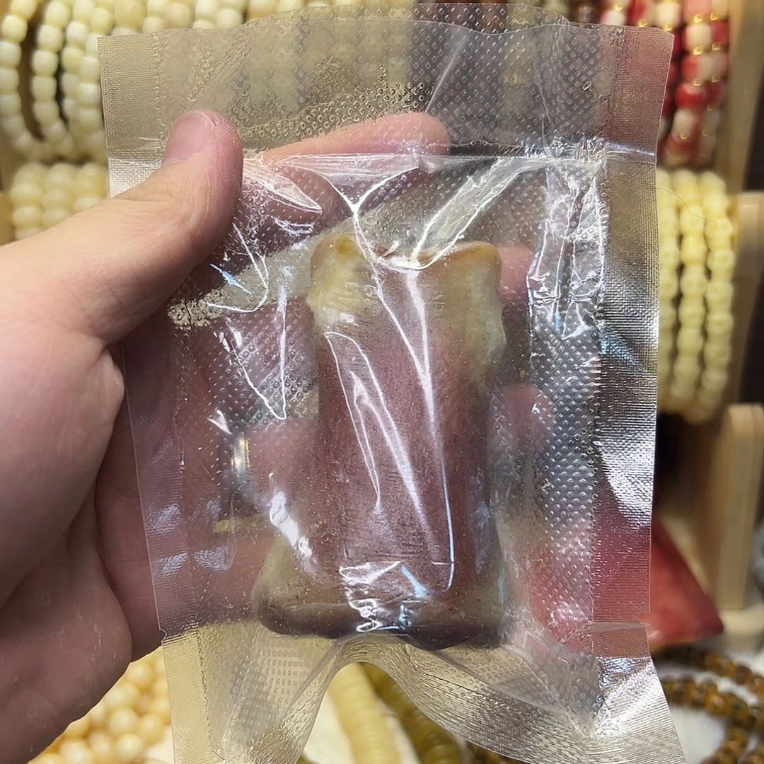 小***刚把件桃核驼骨半血手把件