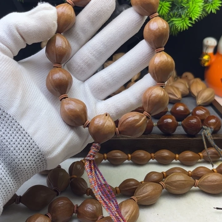 给***四橄榄核手串/手链1.8*2.3原皮三花铁核