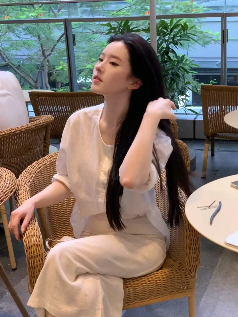 米色亚麻中长款直筒裙女2025夏薄款休闲裙半身裙后开叉一步裙长裙