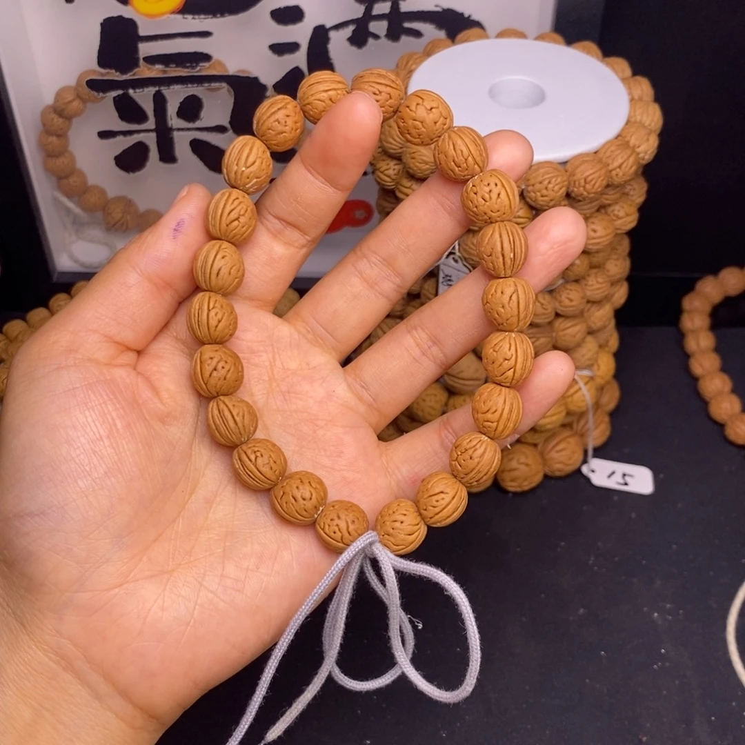 吊坠桃核红皮瓜子脐中脐手持