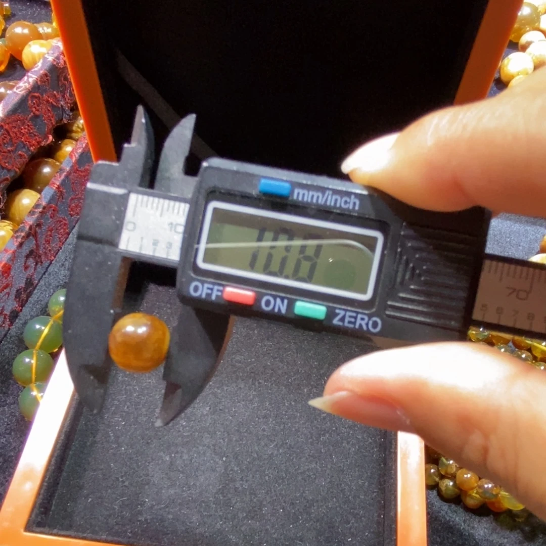 苏***苏裸石琥珀未镶嵌棕蜜10 +打1.0孔