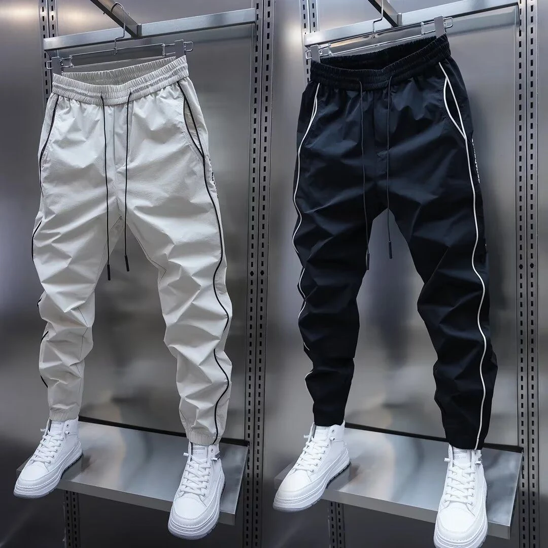 夏季薄款速干痞帅休闲裤拼接打孔透气空调裤侧条拼接束脚哈伦裤男