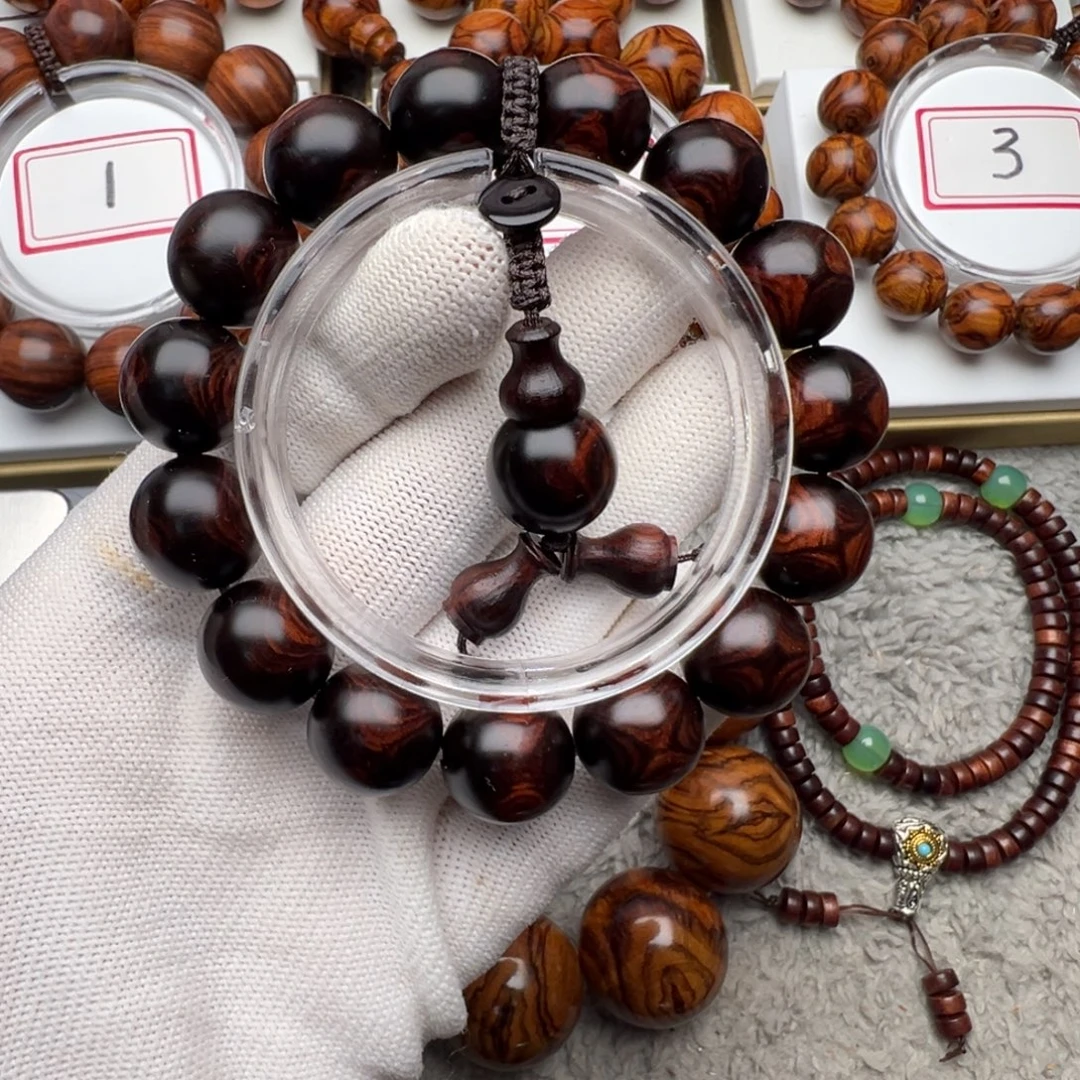 诠***然花梨木类手串/手链1.5老挝紫油梨对眼手串