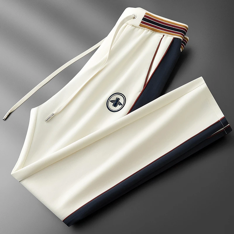 男士时尚撞色拼接秋季微阔休闲裤男潮流刺绣小蜜蜂松紧腰运动卫裤