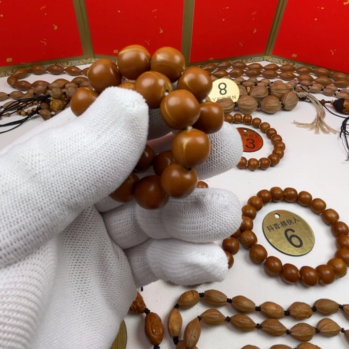 张***茗橄榄核手串闪电购2