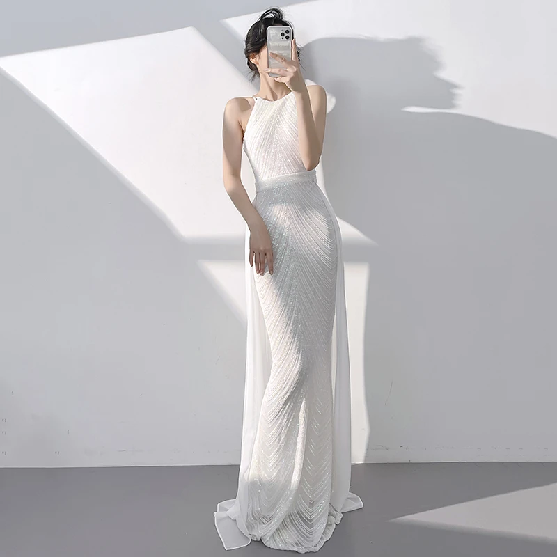 白色晚礼服女2025新款主持人鱼尾亮片气质高端轻奢小众挂脖连衣裙