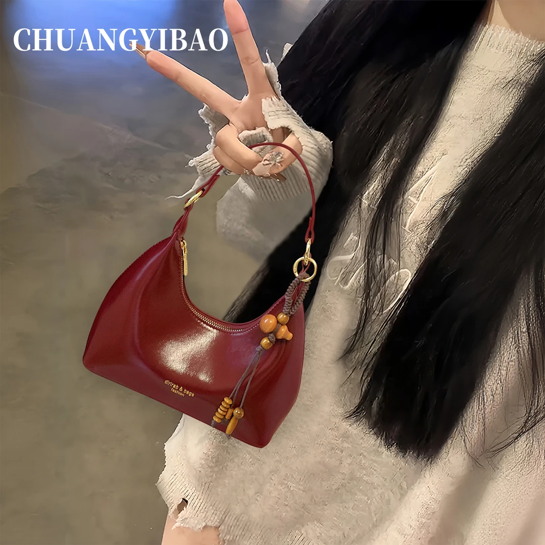 红色腋下月牙包包女式2025新款秋冬轻奢小众设计师高级感斜挎婚包