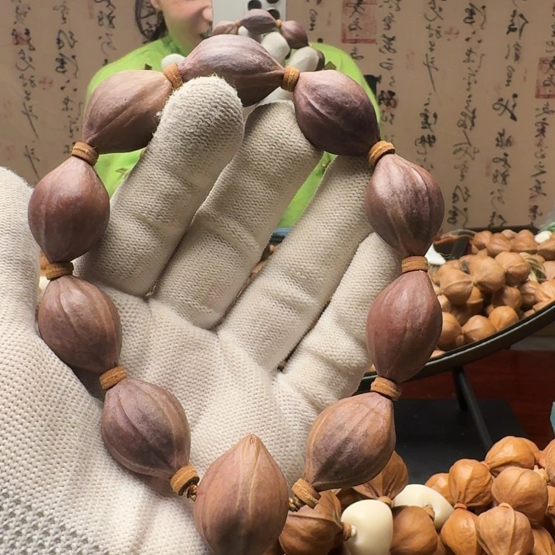 卖***柴橄榄核把件紫皮核