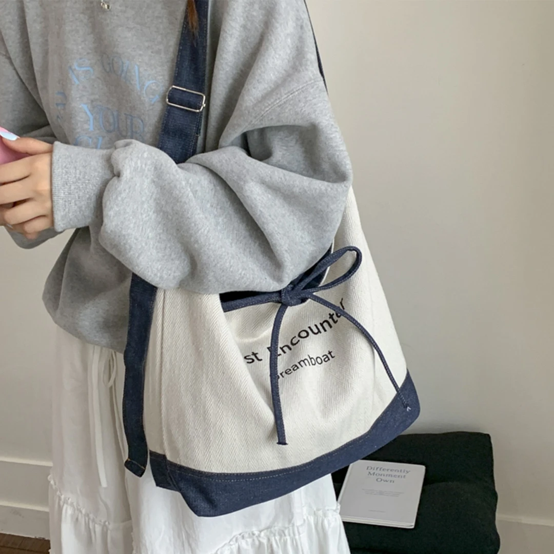 韩国帆布包包女2025新款潮时尚字母双面水桶包懒散风大容量斜挎包