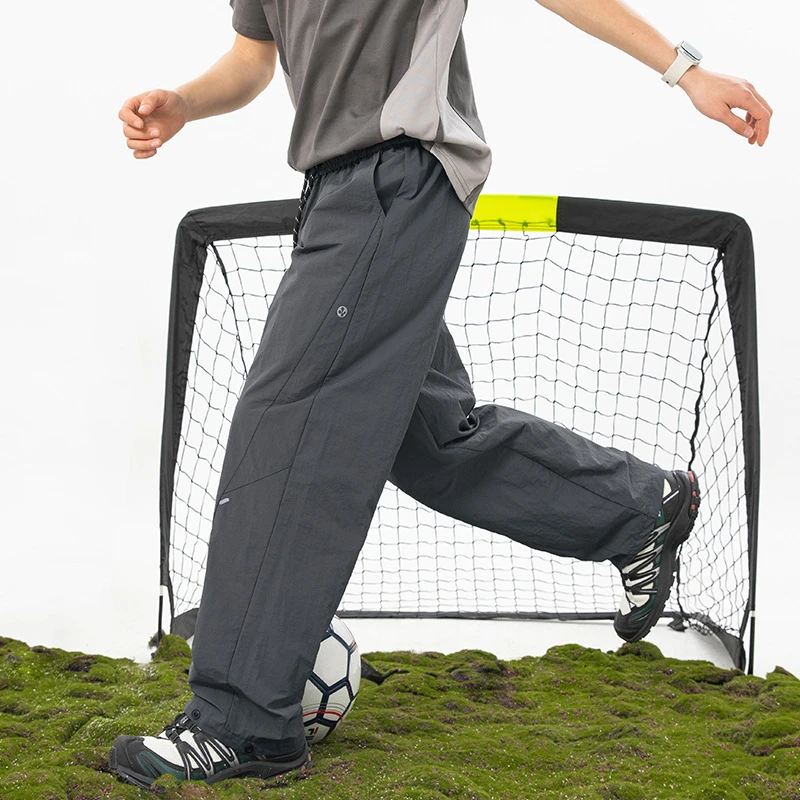 户外防泼水工装休闲裤男新款不规则分割打褶冲锋裤脚口可调长裤