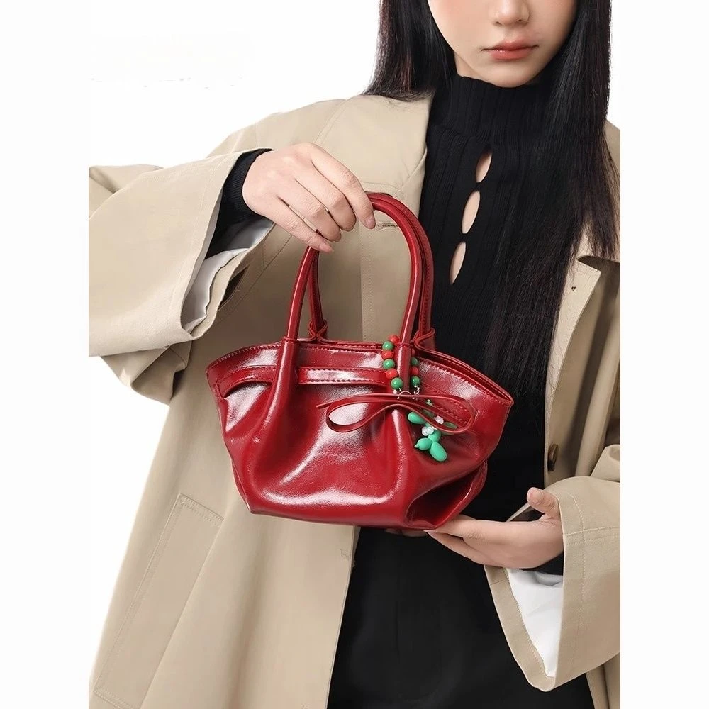 红色手提饺子包包女包2025新款高级感百搭小众通勤斜挎包新娘婚包