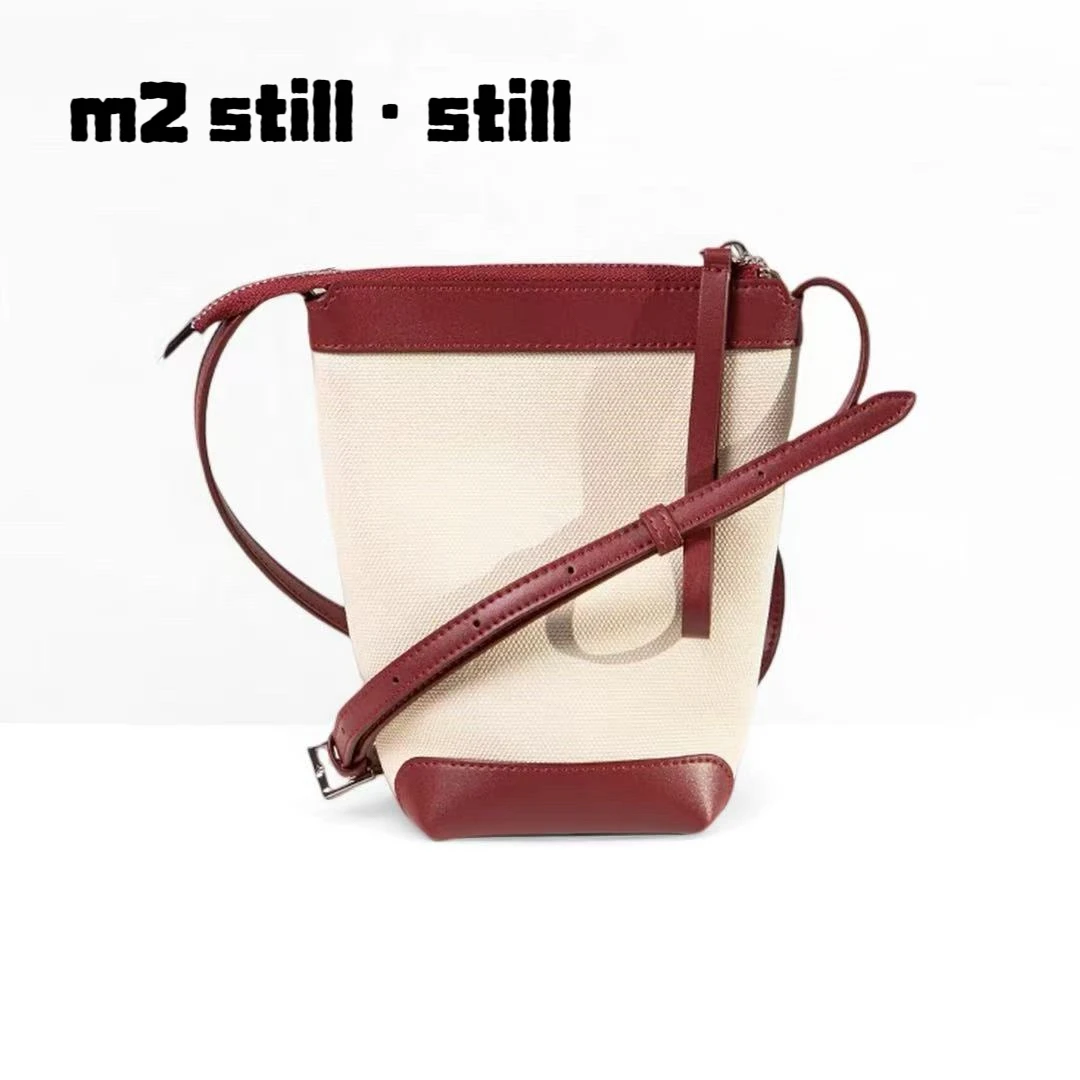 「m2 still·still」两色通体牛皮帆布压纹水桶包